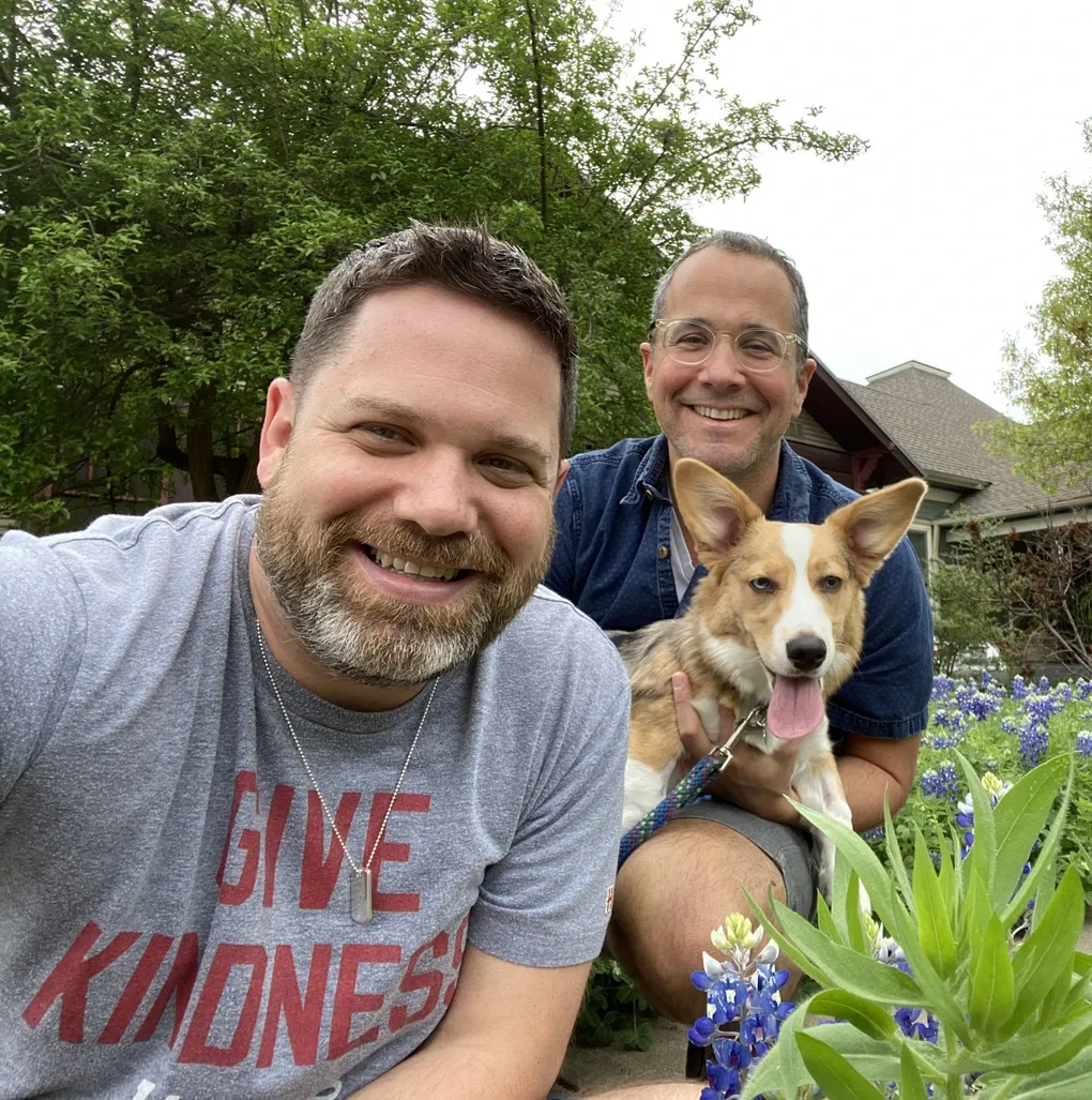 Michael with his husband Doug and their dog Rosie among Texas bluebonnets